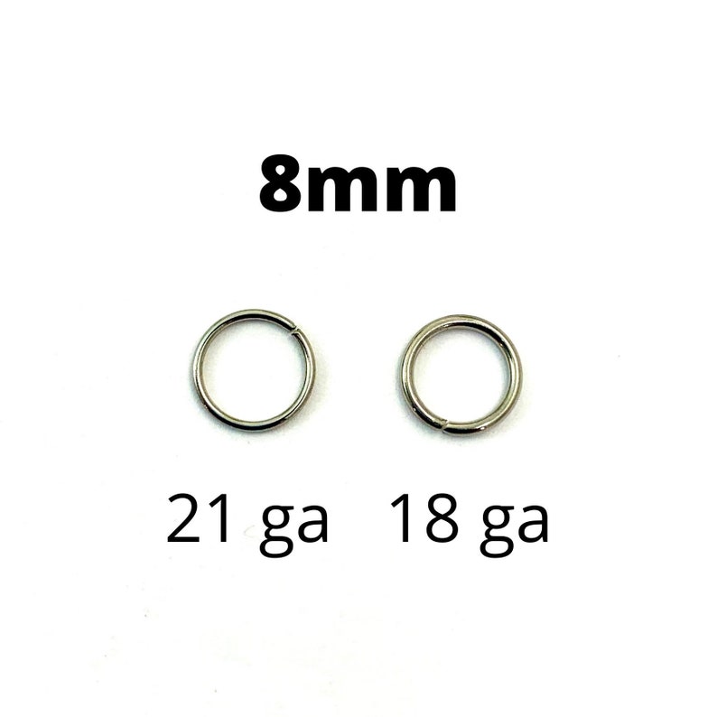 May include: Two silver-colored, circular rings with a diameter of 8mm are displayed against a white background. The text "8mm" is above the rings. Below the rings, the text reads "21 ga 18 ga".