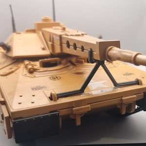 May include: A tan toy tank with a black support bar and a black and tan barrel. The tank has a white star and the words "ACTION FORCE" printed on the side. The tank has a number "51" printed on the top.