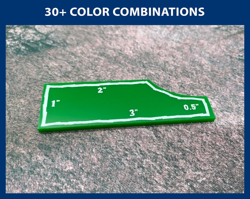 Peut inclure: Un gabarit en plastique vert avec des contours blancs et des mesures en pouces. Le gabarit a la forme d'un rectangle avec un bord incurv&eacute;. Les mesures sont de 1 pouce, 2 pouces, 3 pouces et 0,5 pouce.