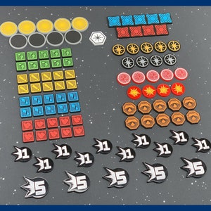 May include: A collection of game tokens and pieces in various shapes and colors. Includes yellow, black, green, blue, red, and orange circular and square tokens, along with black and white tokens with the numbers 1 and 5.