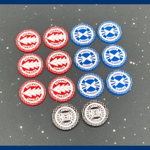 May include: A collection of game tokens in red, blue, and black. The red tokens have the word "EXTRACT" and an arrow design. The blue tokens say "SECURE" with a cross design. The black tokens say "ASSET".