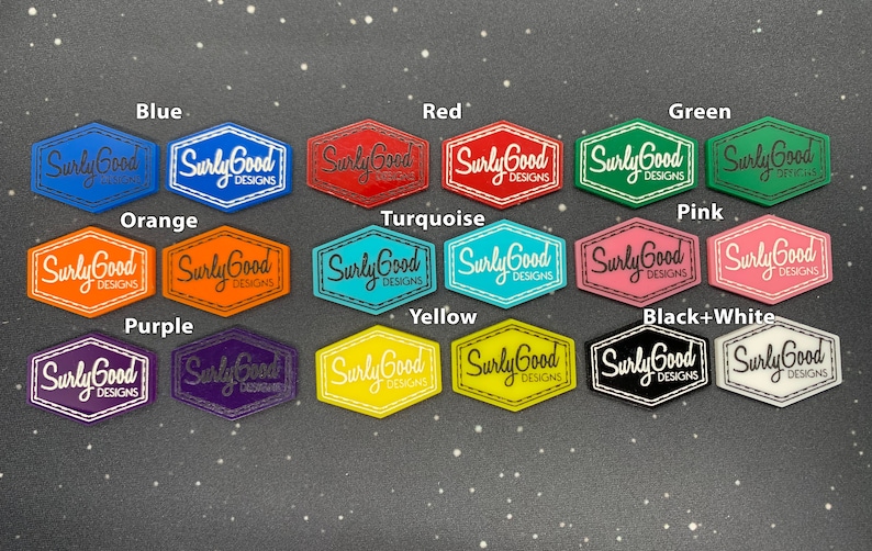 May include: A set of 12 hexagonal shaped logo stickers in various colours, including blue, red, green, orange, turquoise, pink, purple, yellow, and black and white. Each sticker features the text "Surly Good Designs" in white lettering.