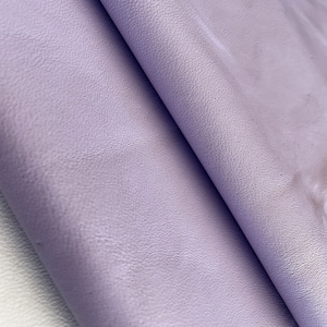 May include: Close-up of a soft, textured, lilac-colored leather fabric.