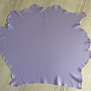 May include: A large piece of light purple leather. The leather is smooth and has a slight sheen.