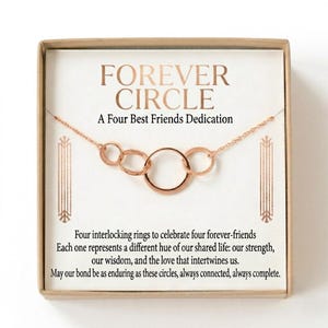 May include: A rose gold necklace featuring four interlocking rings of varying sizes, presented in a square box. The card inside reads: FOREVER CIRCLE A Four Best Friends Dedication. Four interlocking rings to celebrate four forever-friends.