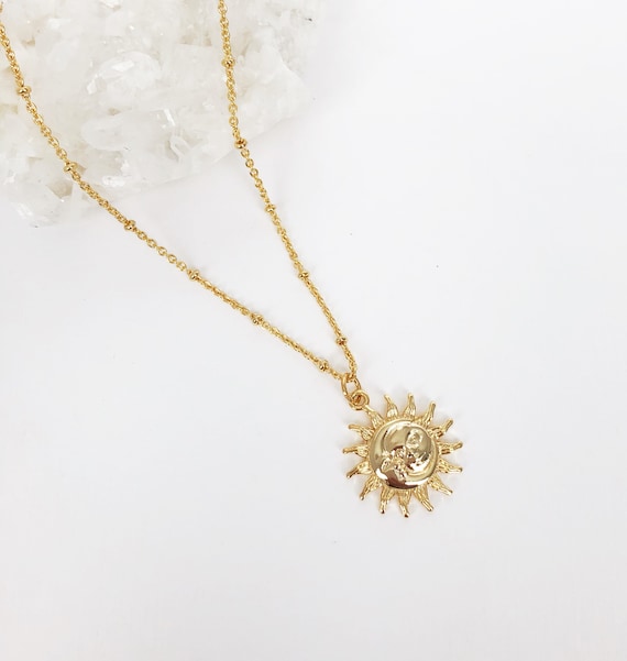 Gold necklace with sun best sale pendant