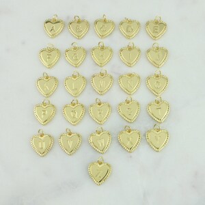 May include: A set of 26 gold heart-shaped charms, each featuring a different letter of the alphabet. The charms are ideal for adding a personalised touch to jewellery.
