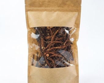 May include: A brown kraft paper stand-up pouch with a clear rectangular window on the front. The pouch is filled with a collection of thin, dark brown, dried woody roots or herbal stems that are visible through the transparent plastic section.