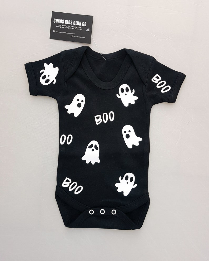 May include: Black baby onesie with white ghost and "BOO" graphics.