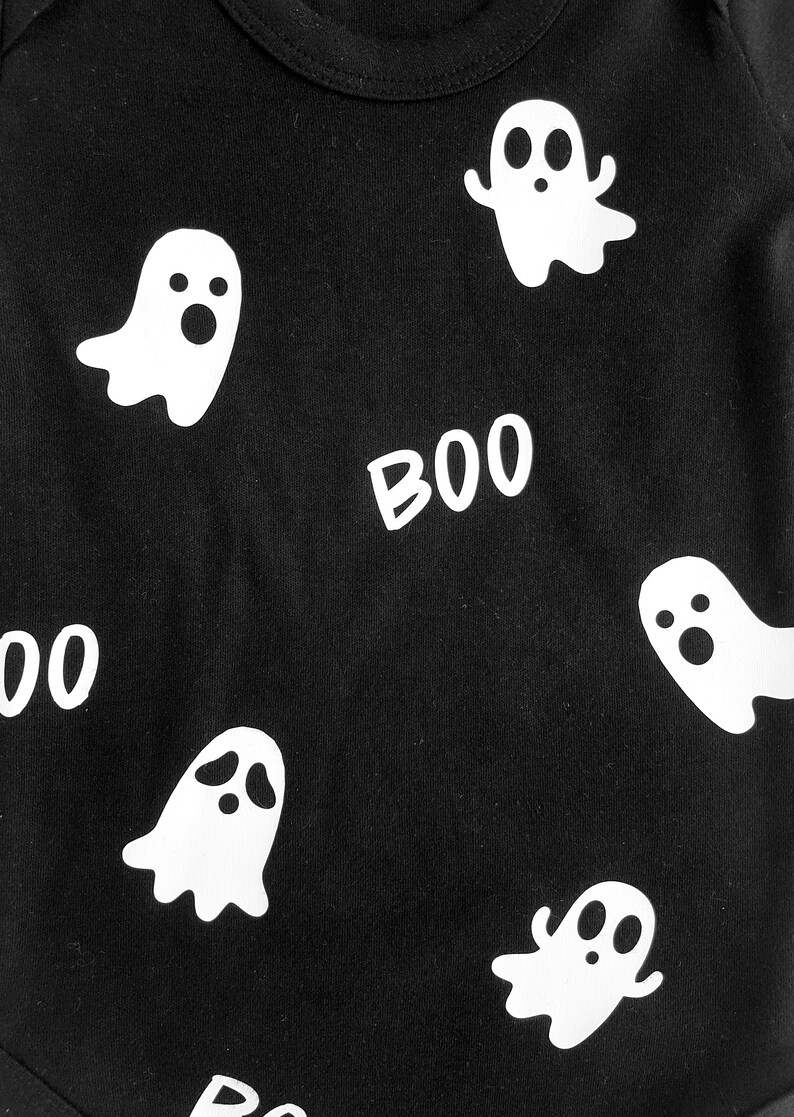 May include: Black bodysuit with a white ghost and "BOO" print.