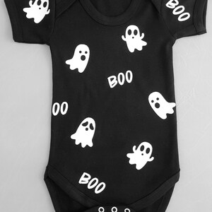 May include: Black baby onesie with white ghost and "BOO" print.