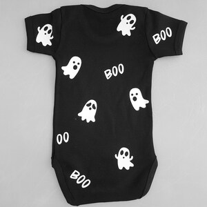May include: Black baby onesie with white ghost and "BOO" designs.