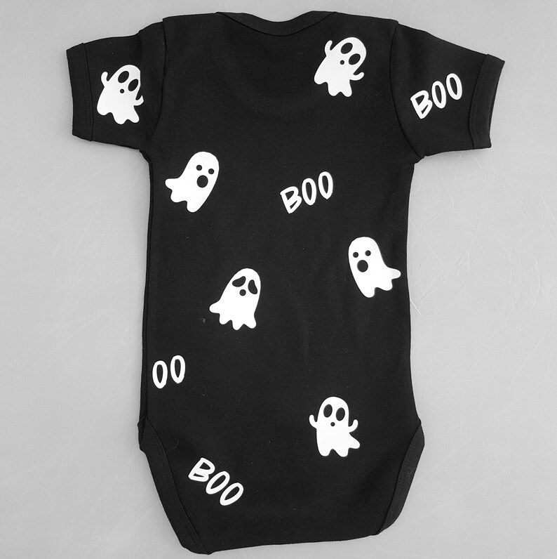 May include: Black baby onesie with white ghost and "BOO" designs.