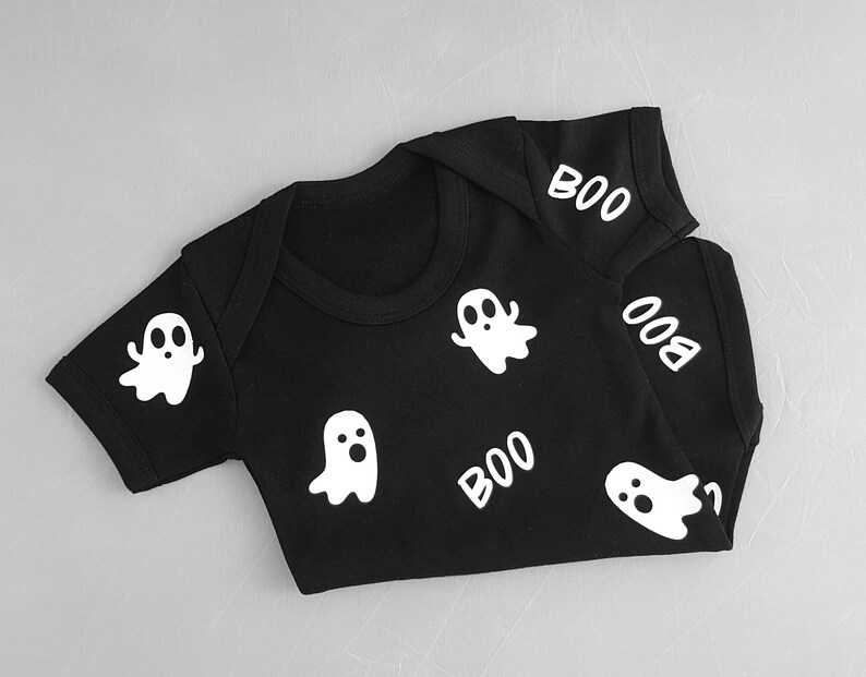 May include: Black baby onesie with white ghost and "BOO" designs.