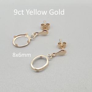 May include: Two 9ct yellow gold earring settings with an oval shape, measuring 8x6mm. The earrings have a post and dangle design. The text "9ct Yellow Gold" and "8x6mm" are visible.