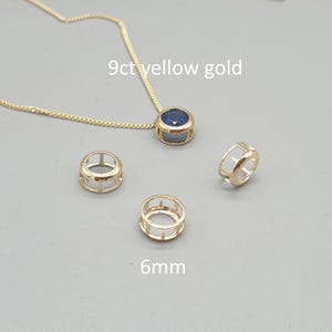 May include: A 9ct yellow gold necklace featuring a round blue gemstone pendant, accompanied by three empty 6mm yellow gold pendant settings. The metal components are polished and circular, with the necklace chain attached to the main setting.