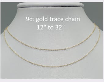 May include: A 9ct gold trace chain necklace with a delicate link design. The text on the image reads 9ct gold trace chain 12" to 32", indicating the available length options for this fine jewelry piece displayed on a white neck form.