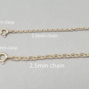 May include: Two gold-colored chain necklaces with clasps are displayed against a gray background. The top chain has a 5mm clasp and a 2.0mm chain. The bottom chain has a 5.5mm clasp and a 2.5mm chain.