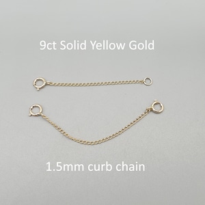 May include: Two 9ct solid yellow gold chain extenders. The top chain is straight, and the bottom chain is curved. Both chains have a 1.5mm curb chain design. Each chain has a clasp on one end and a ring on the other.