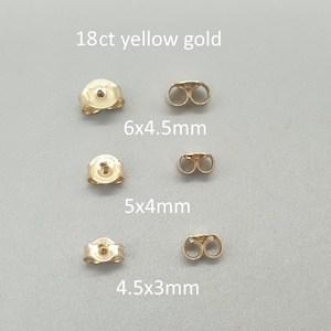 May include: Three pairs of 18ct yellow gold earring backs in varying sizes: 6x4.5mm, 5x4mm, and 4.5x3mm. Each pair includes a butterfly-style back and a corresponding post component, all displayed against a gray background.