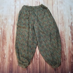 May include: Green, brown, and teal paisley print pants with an elastic waistband.