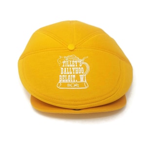 May include: A yellow Tilley's Ballyhoo Beloit, WI hat with a white embroidered logo of a beer stein.