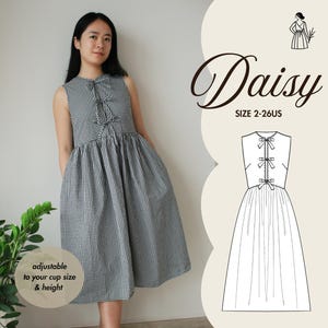 May include: A black and white gingham dress with a ruffled neckline and adjustable straps. The dress is called "Daisy" and is available in sizes 2-26 UK.