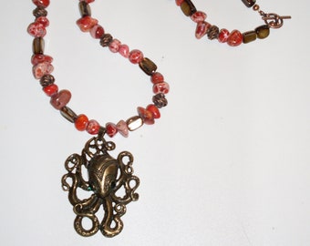 Dreams of the Octopus God necklace: intricate octopus pendant, beads of red sea-sediment jasper, brown shell, lacy copper