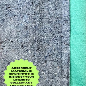 May include: Close-up of a gray fabric liner with a green fabric border. A green starburst sticker with the text "Absorbent Material is sewn into the inside of your liners to collect any liquid waste" is attached to the fabric.