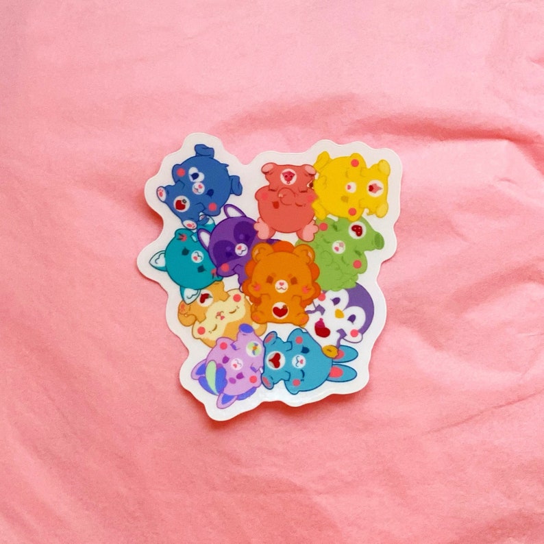 May include: A sticker sheet featuring a group of colorful cartoon bears with different expressions. The bears are arranged in a circle and have hearts on their cheeks.