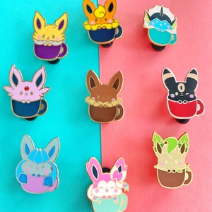 May include: Nine enamel pins featuring different Pokemon characters in various colors, each holding a cup of coffee or tea. The pins are arranged in two rows on a blue and pink background.