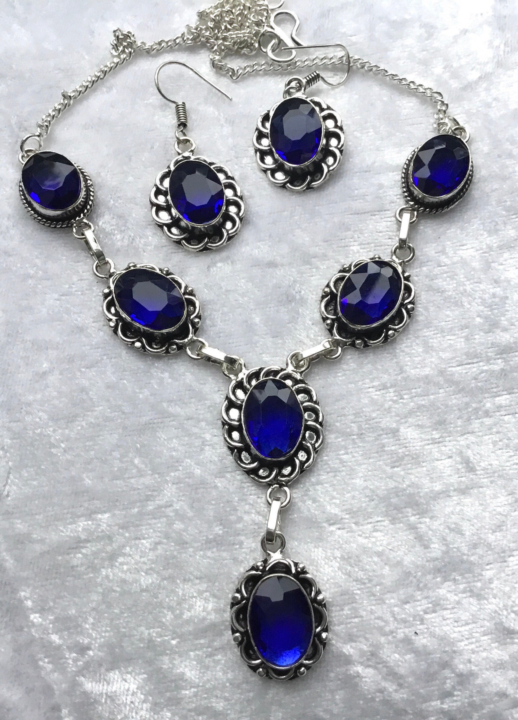 Tanzanite necklace and earrings set with ornate silver work. Etsy