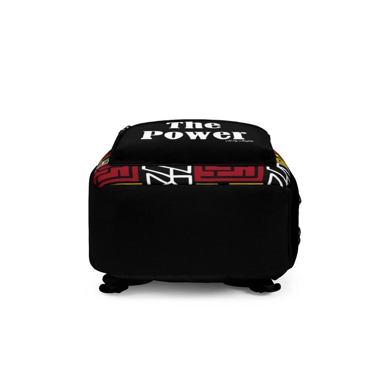 May include: Black backpack with a red, yellow, and black patterned bottom. The top of the backpack has the text "The Power" in white.
