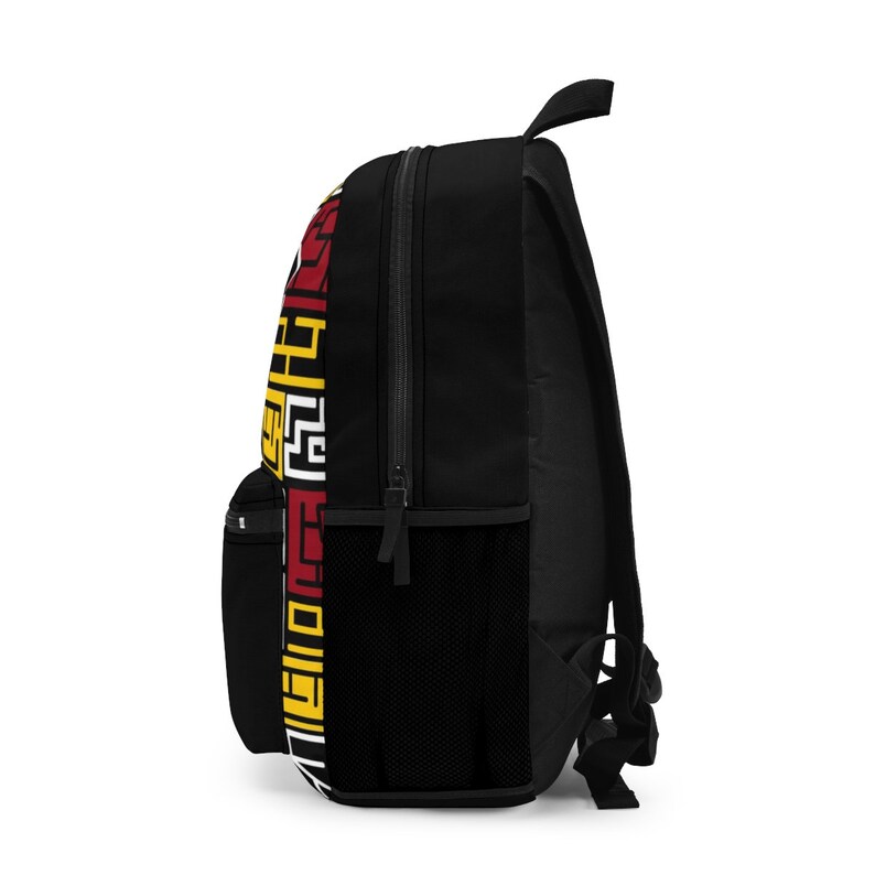 May include: Black backpack with a red, yellow, and white geometric pattern on the side. The backpack has a zippered front pocket and a mesh pocket on the side.