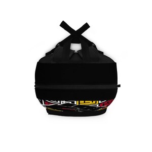 May include: Black backpack with a colorful geometric design on the bottom. The backpack has a zippered closure and adjustable straps.