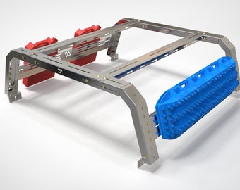 May include: A silver metal truck bed rack with two red jerry cans and a blue traction mat. The rack has a black metal grid and the text "WAY OUT" is visible on the jerry can.