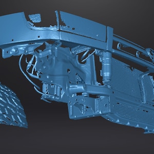 May include: A blue 3D model of a car front end, including the bumper, grille, and radiator. The model is disassembled, with the fender and tire separate from the main body.