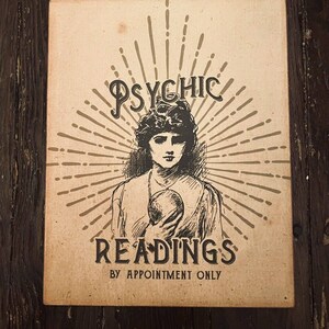 May include: A vintage-style poster advertising psychic readings. The poster features a black and white illustration of a woman holding a crystal ball. The text on the poster reads "Psychic Readings by Appointment Only."