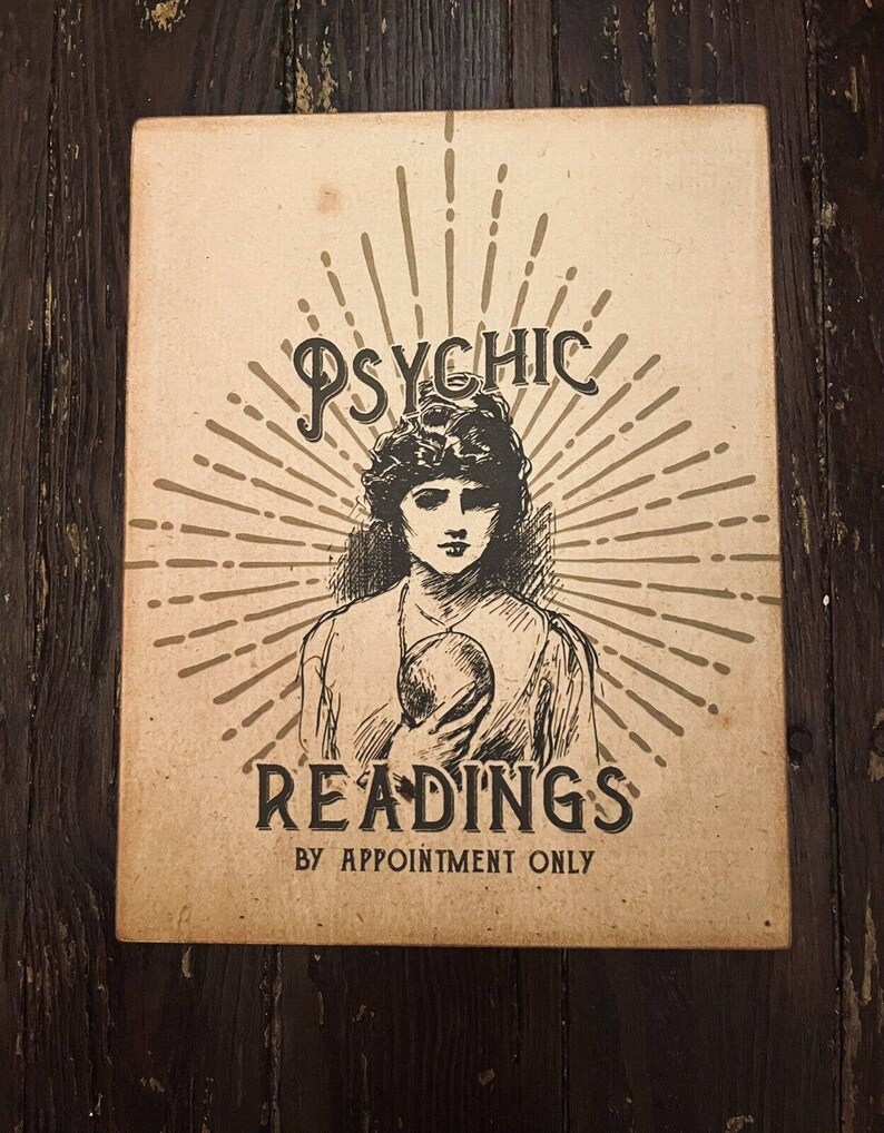 May include: A vintage-style poster advertising psychic readings. The poster features a black and white illustration of a woman holding a crystal ball. The text on the poster reads "Psychic Readings by Appointment Only."
