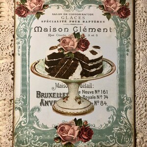 May include: Vintage advertisement for Maison Cl&eacute;ment, a shop specializing in ice cream for baptisms. The ad features a decorative border with roses and a plate of chocolate cake. The text reads "Salon de Consommation Glaces Specialit&eacute; pour Bapt&ecirc;mes Maison Cl&eacute;ment Rue Courte 3 et 5 Maiso BRUXELLES ANVE detail: e Neuve N&ordm; 161 Royale N&deg; 74 N&deg; 84."