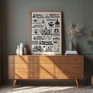 May include: A framed print featuring various black and white Space Shuttle logos and text. The print is displayed on a wooden cabinet with a mid-century modern design. Decorative vases and a plant are also present.