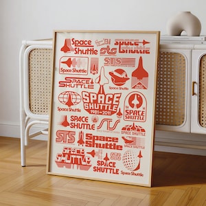 May include: A framed poster featuring a collection of red Space Shuttle logos and graphics on a cream background. The design includes various stylized shuttle silhouettes, text reading Space Shuttle 1981-2011, and geometric patterns.