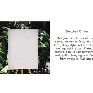 a white canvas with a wooden easel on top of it