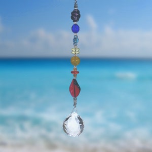 May include: A crystal suncatcher with a clear crystal ball and a beaded chain with rainbow colored beads.