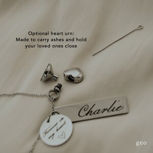 May include: Silver heart urn necklace with a small funnel and a screw top. The necklace has a tag that says "Forever in my heart" and a larger tag that says "Charlie".