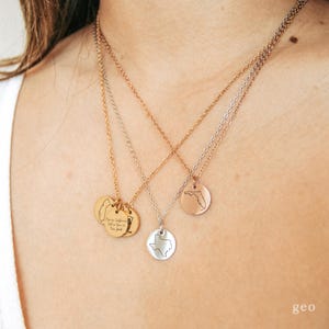 May include: Three gold necklaces with different charms. The charms are a state of Florida, a state of Texas, and a charm with the text "There is California, but we have our own kind of good".