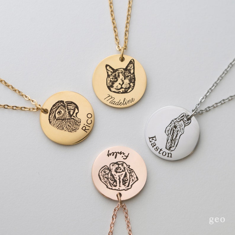 May include: Four gold, silver, and rose gold necklaces with round pendants featuring engraved images of a cat, parrot, dog, and horse. Each pendant has a name engraved below the image: Madeline, Rico, Finley, and Easton.