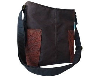 Brown waxed cotton cross body/shoulder bag, adjustable strap, zip closure. Distressed style pockets.