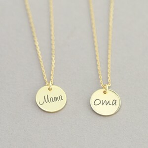 May include: Two gold necklaces with round pendants. The pendant on the left says "Mama" and the pendant on the right says "Oma".
