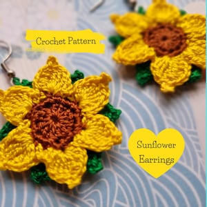 May include: Crochet pattern for sunflower earrings. The earrings are yellow with green leaves and a brown center. The text "Sunflower Earrings" is written on a yellow heart.